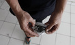 Cepi, one of the residents of the flat, show the coal dust he collected from the floor of...