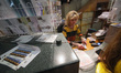 KYIV, UKRAINE - APRIL 18, 2022 - A manager sells the Russian Warship, Go Fuck Yourself pos...