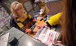 KYIV, UKRAINE - APRIL 18, 2022 - A manager sells the Russian Warship, Go Fuck Yourself pos...