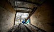 ZAPORIZHZHIA, UKRAINE - APRIL 16, 2022 - A worker picks wood boards from a truck as a 70-y...