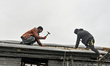 ZAPORIZHZHIA, UKRAINE - APRIL 16, 2022 - Labourers work to repair a 70-year-old building s...