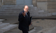 Justice Minister Eric Dupond-Moretti signals to journalists that he does not hear their qu...