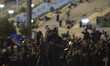 An Iranian man holds a copy of the Muslims holy book of Koran on his head while praying in...