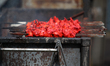 Skewers of Lahori chicken tikka kabobs on a grill outside a Pakistani restaurant in Little...