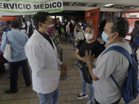 Medical personnel offer reports to people in a vaccination unit at the Constitución de 1917 metro station in Mexico City, where the AstraZen...