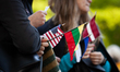 Protesters hold the flags of the United States, Lithuania, Estonia, and Latvia (left to ri...