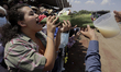 A person drinks pulque during the Donkey Fair on the occasion of International Labor Day i...