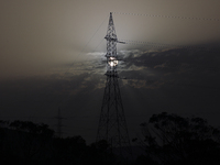 The sun rises in a haze behind a power line near a power plant in the Mediterranean port of Limassol. Cyprus, Wednesday, 4 May, 2022. Energy...