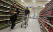 An Iranian man pushes a cart as he and his wife shopping in Tehran's Megamall on September...