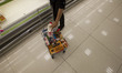 An Iranian woman places a milk bottle in a cart while shopping in Tehran's Megamall on Sep...