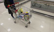 An Iranian woman carries goods by a cart while shopping in Tehran's Megamall on September...