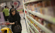 An Iranian woman looks at goods displayed on shelves while shopping in Tehran's Megamall o...