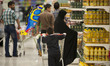 An Iranian young boy pushes a cart as he and her mother attend Tehran's Megamall for shopp...