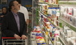 An Iranian man looks at dairy products displayed for sale on shelves in Tehran's Megamall...