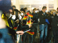 fans are seeing waving the German flags waiting to German astronaut Matthias Maurer arrives at  Federal Defence transportwing in Cologne, Ge...