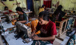 Workers sew batik clothing products traditional Javanese textile called batik at low-lying...