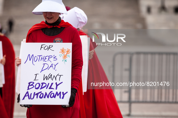 Demonstrators dressed as handmaids from The Handmaid's Tale, depart the Capitol en route to the Supreme Court.  The Handmaids Army DC came t...
