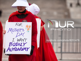 Demonstrators dressed as handmaids from The Handmaid's Tale, depart the Capitol en route to the Supreme Court.  The Handmaids Army DC came t...