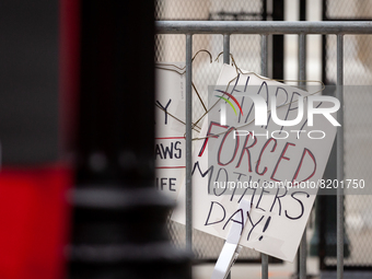 A sign on a barricade at the Supreme Court wishes people a "happy forced Mother's Day,' left there by a demonstrator. It provided a backdrop...
