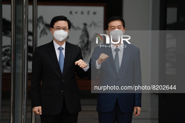 (Left) John Lee, Chief Executive elect and (Rigth) Lou Huining Director of the liaison office pose for a photo at the front door of the liai...
