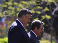 Cyprus' president Nicos Anastasiades, right, walks with Croatian Prime Minister Andrej Plenkovic before their meeting at the presidential pa...