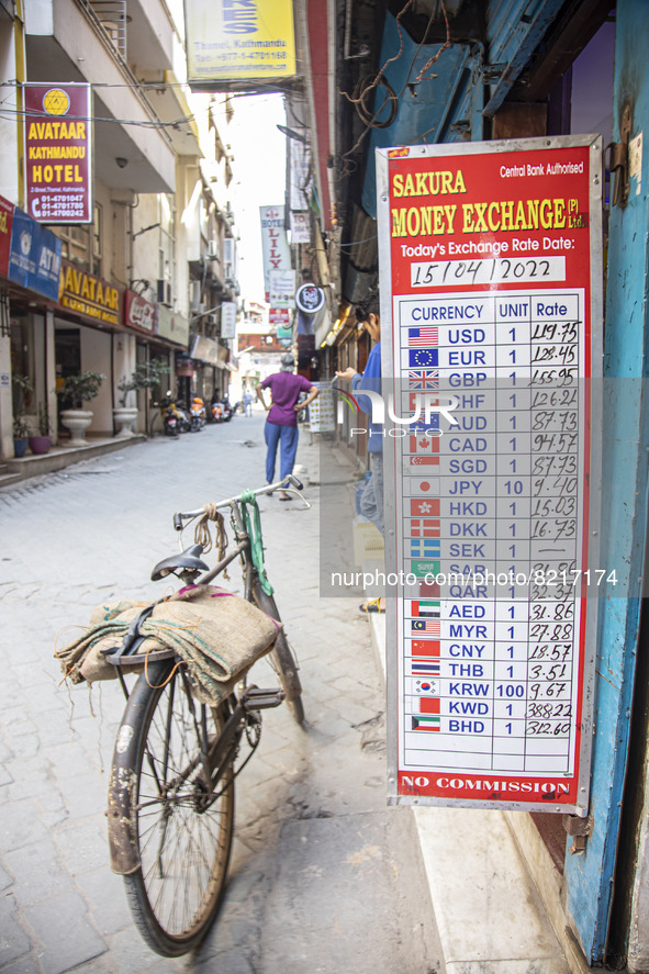 Closeup at the board with the daily exchange rates next to a standing bicycle. Money Exchange Centre office, a place for exchanging Foreign...