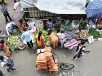 A wholesale market in Kolkata, India, 13 May 2022. A rickshaw puller walks past a wholesale market in Kolkata, India, 13 May, 2022. A day la...