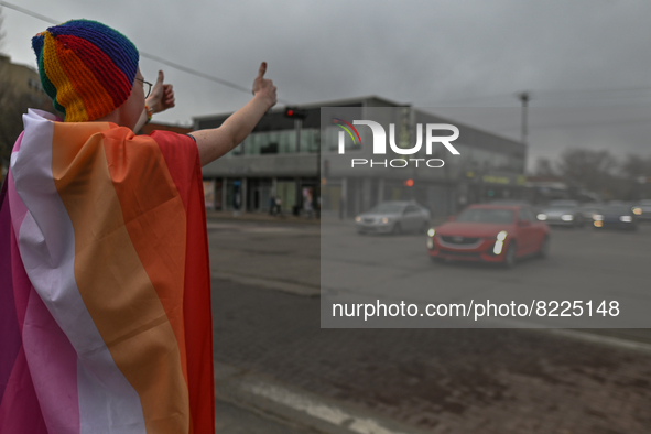 An activist interacting with passing cars.
More than 100 local LGBTQ2S + supporters gathered Friday evening at the southeast corner of Whyte...