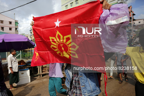 A young demonstrator holds a flag during an anti-coup protest in Yangon, Myanmar on May 16, 2022.
 