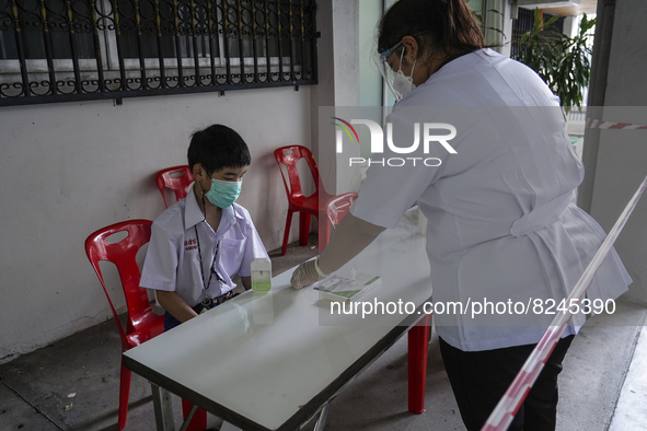 A student undergoes a Rapid Antigen Test at Assumption College resuming classes in Bangkok, Thailand, 17 May 2022. 