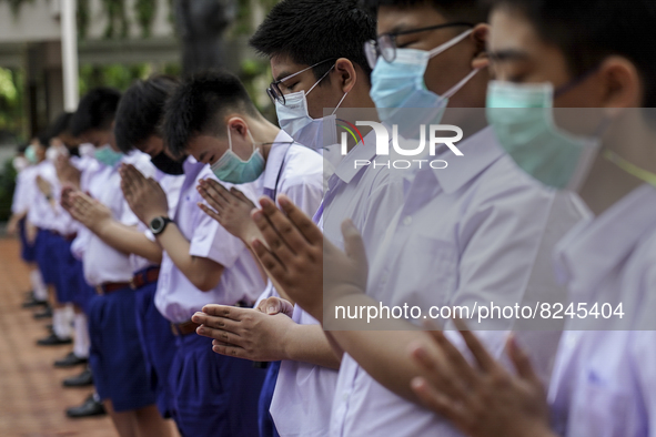 Students wear facemasks, as they attend a flag-raising ceremony before the start of classes at Assumption College in Bangkok, Thailand, 17 M...