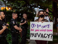 Pro-choice protesters walk past police and federal marshals standing in front of Justice Brett Kavanaugh's house in Chevy Chase, MD.  Demons...