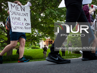 Pro-choice protesters march past Chief Justice John Roberts’ house in Chevy Chase, MD.  Police and federal marshals are currently protecting...
