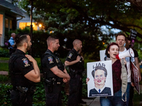 Pro-choice protesters walk past police and federal marshals standing in front of Justice Brett Kavanaugh's house in Chevy Chase, MD.  Demons...