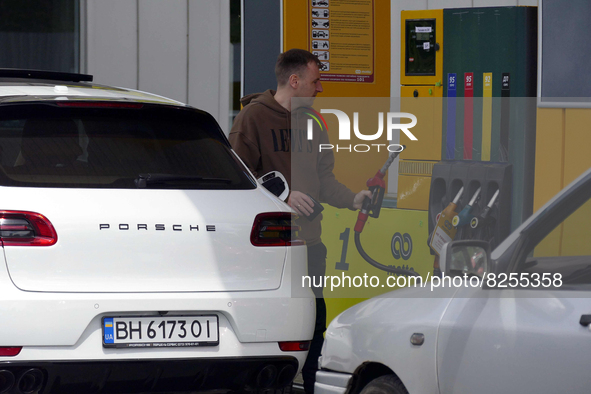 ODESA, UKRAINE - MAY 19, 2022 - A driver holds a nozzle of a fuel dispenser at a petrol station in Odesa, southern Ukraine. This photo canno...