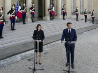 Moldova's President Maia Sandu (L)  listens the welcome speech of the France's President Emmanuel Macron (R) at the presidential Elysee Pala...