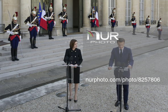 Moldova's President Maia Sandu (L)  listens the welcome speech of the France's President Emmanuel Macron (R) at the presidential Elysee Pala...