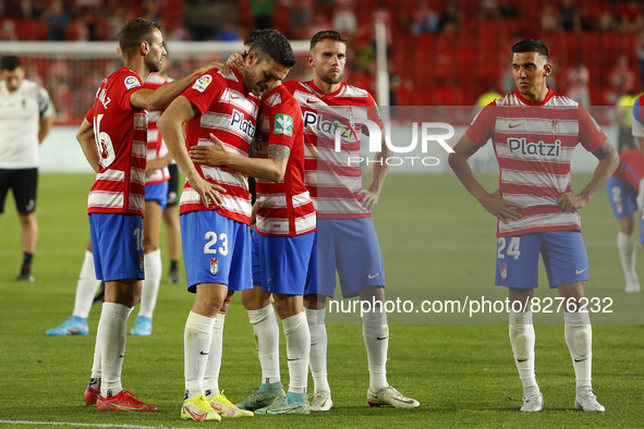 Players of GranadaCF react after they descend to second division during the La Liga match between Granada CF and RCD Espanyol at Nuevo Los C...