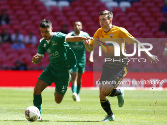 LONDON, ENGLAND - MAY 22:Lewis Markey of Newport Pagnell Town gets tackled by Tom Biggs of Littlehampton Town during The Buildbase FA Vase F...