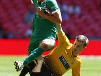 LONDON, ENGLAND - MAY 22:Lewis Markey of Newport Pagnell Town gets tackled by Tom Biggs of Littlehampton Town during The Buildbase FA Vase F...