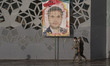 Two IRGC military personnel walk past a portrait of the Islamic Revolutionary Guard Corps'...