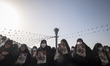 Iranian veiled women hold portraits of the Islamic Revolutionary Guard Corps’ (IRGC) colon...