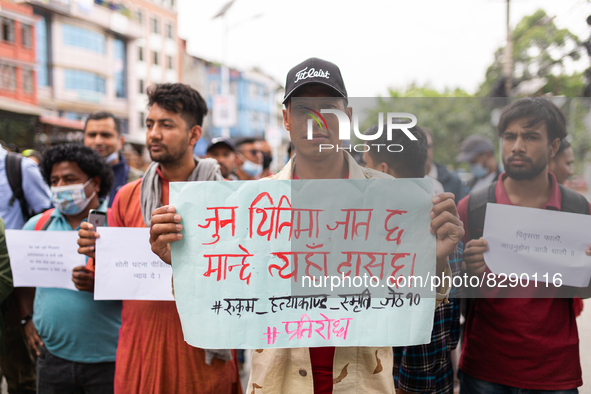 Activists hold placard during a protest against caste system and justices for six men from lower caste who were killed by vicious crowd in R...