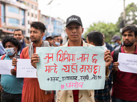 Activists hold placard during a protest against caste system and justices for six men from lower caste who were killed by vicious crowd in R...