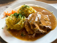 A roast in sauce with potatoes is seen in a milk bar in Krakow, Poland on May 24, 2022. (
