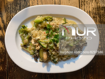 Risotto with chicken and vegetables is seen on a restaurant table in this illustration photo taken in Krakow, Poland on May 24, 2022. (