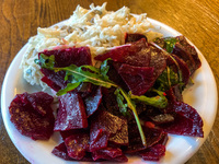 Beetroot and celery salad are seen on a vegetarian restaurant table in Krakow, Poland on May 25, 2022. (