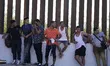 Migrants wait to be transported to a Border Patrol Detention center on May 26 2022 in Eagl...