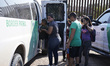 A  migrant family with a small child are loded into Border Patrol vans on May 26 2022 in E...