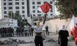 protesters raising Bahrain flags and facing riot police during Tamarod rally day 2 , The d...